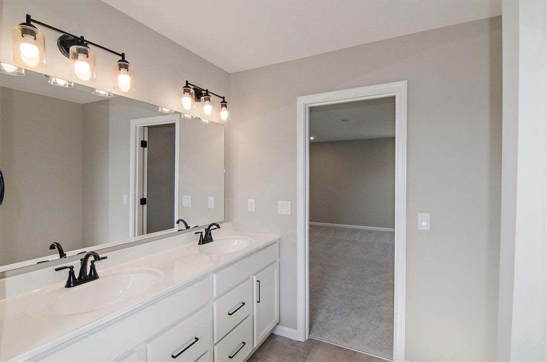 Clean lines and a spacious dual vanity define this