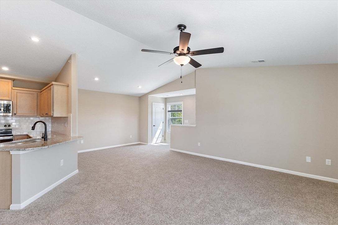 Plush carpeting and vaulted ceilings enhance this