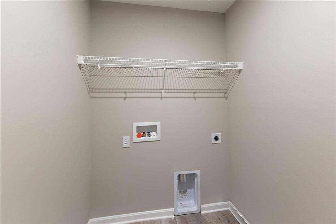 An organized laundry closet provides dedicated she