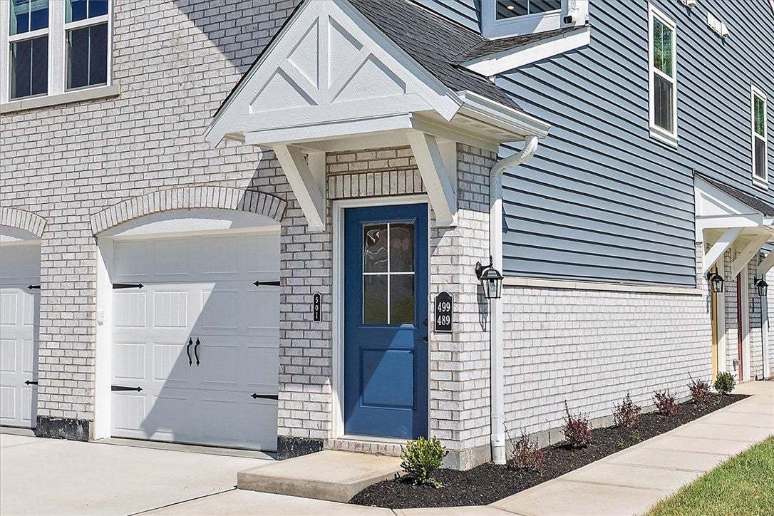 Crisp masonry and classic siding define the welcom