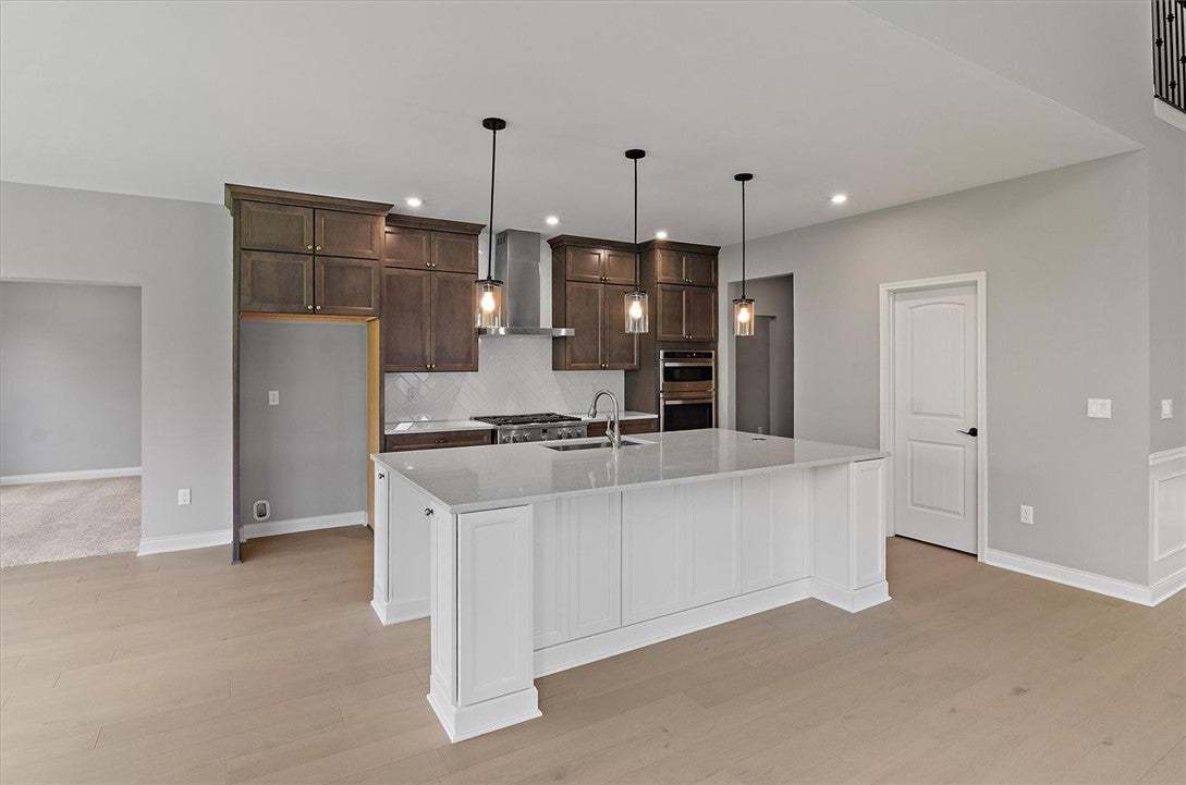 Gleaming hardwood floors and a spacious stone-coun