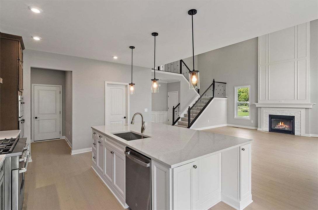 Polished stone counters and sleek wood floors flow