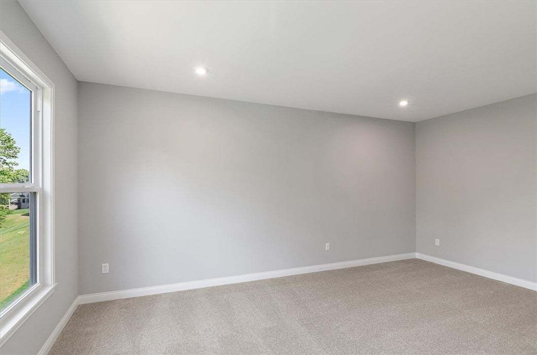Recessed lighting and soft carpeting create a sere