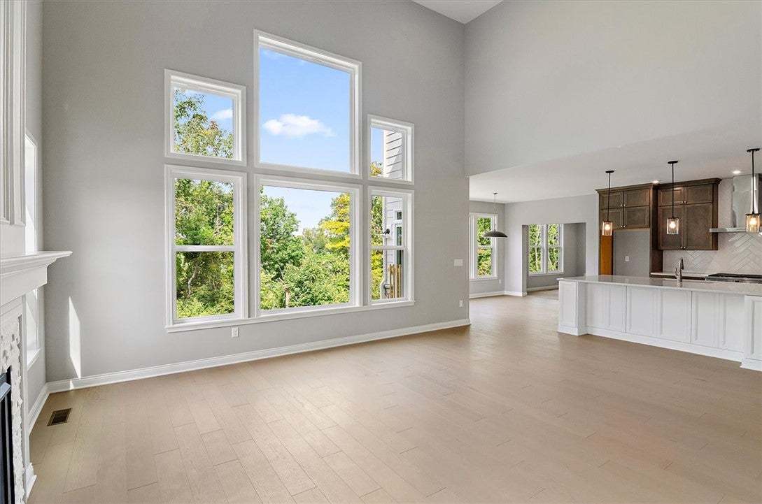 Massive multi-tiered windows frame leafy views in