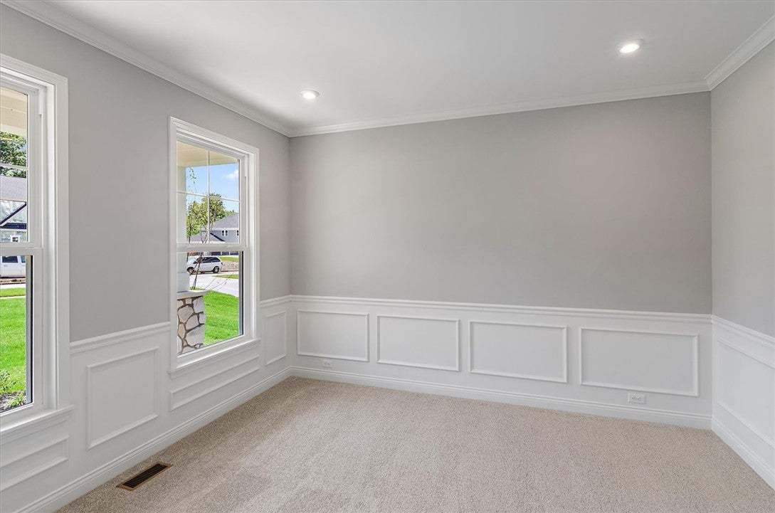 Classic wainscoting and crown molding accent this