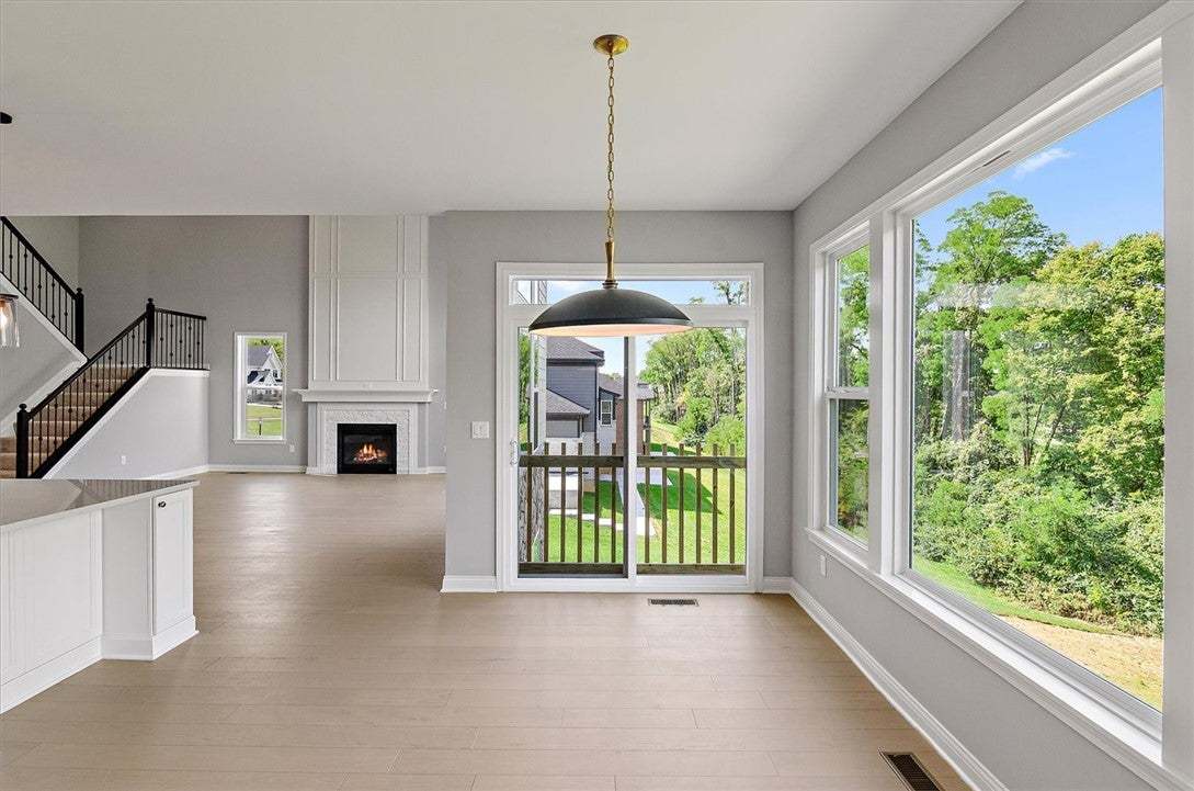 Generous windows frame lush backyard views in this