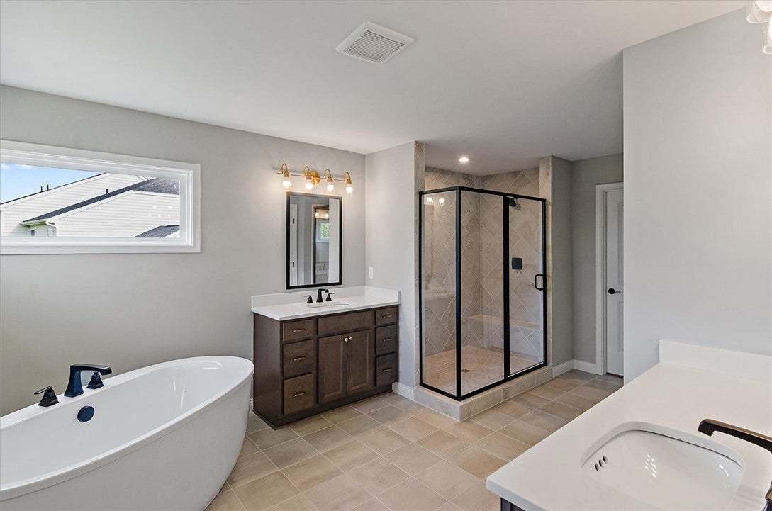 Tiled flooring and a separate glass-enclosed showe