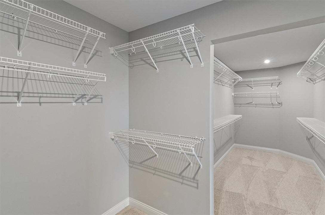 An organized walk-in closet features abundant wire