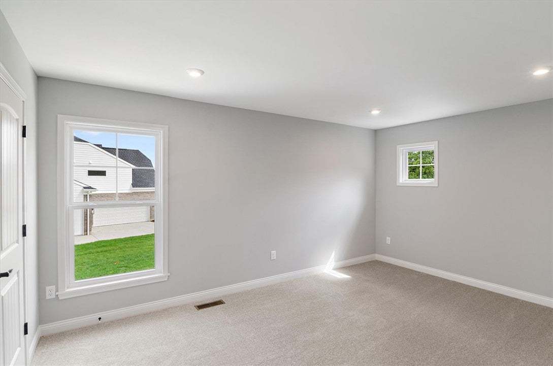 Smooth walls and neutral carpeting define this ver