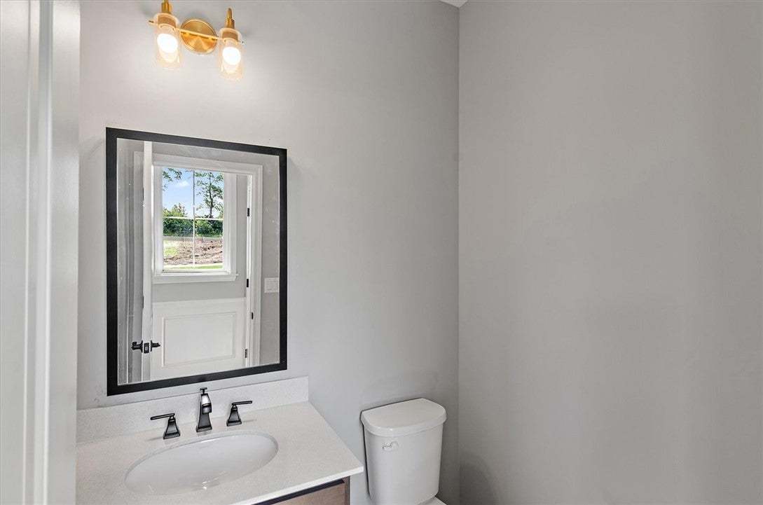 Smooth countertops and contemporary fixtures defin