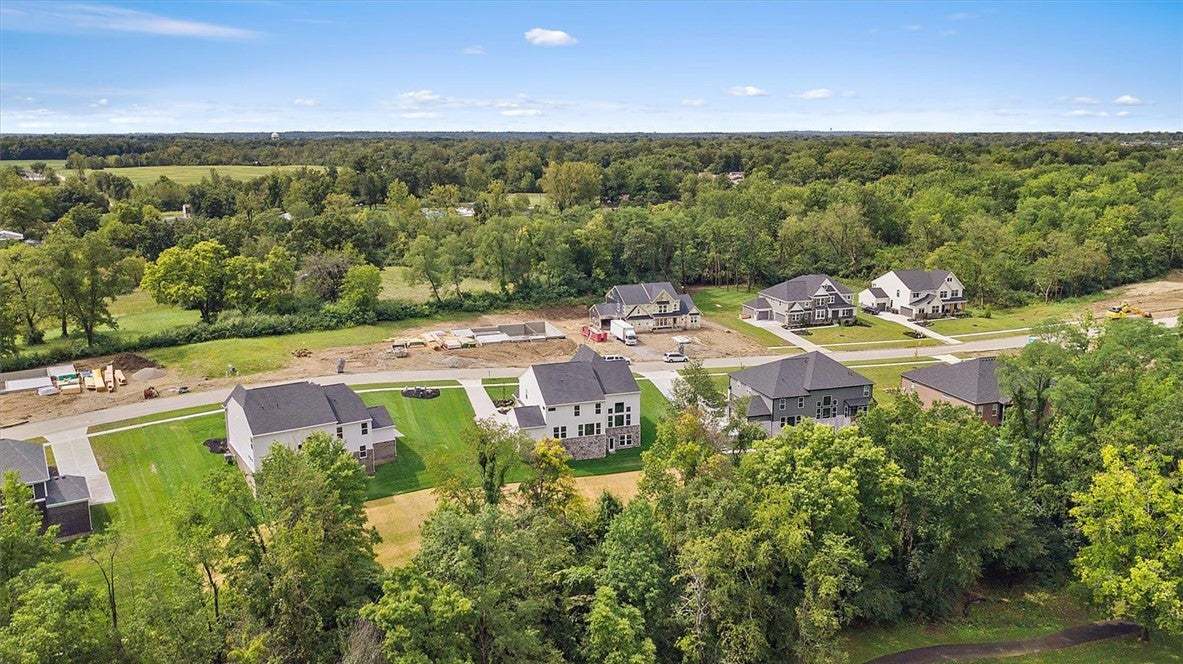 Lush woodlands encircle this scenic neighborhood o