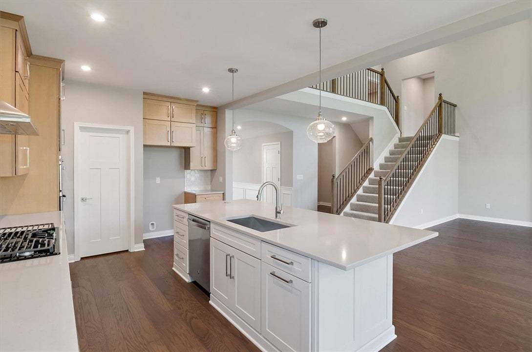 Gleaming hardwood floors and a spacious island anc
