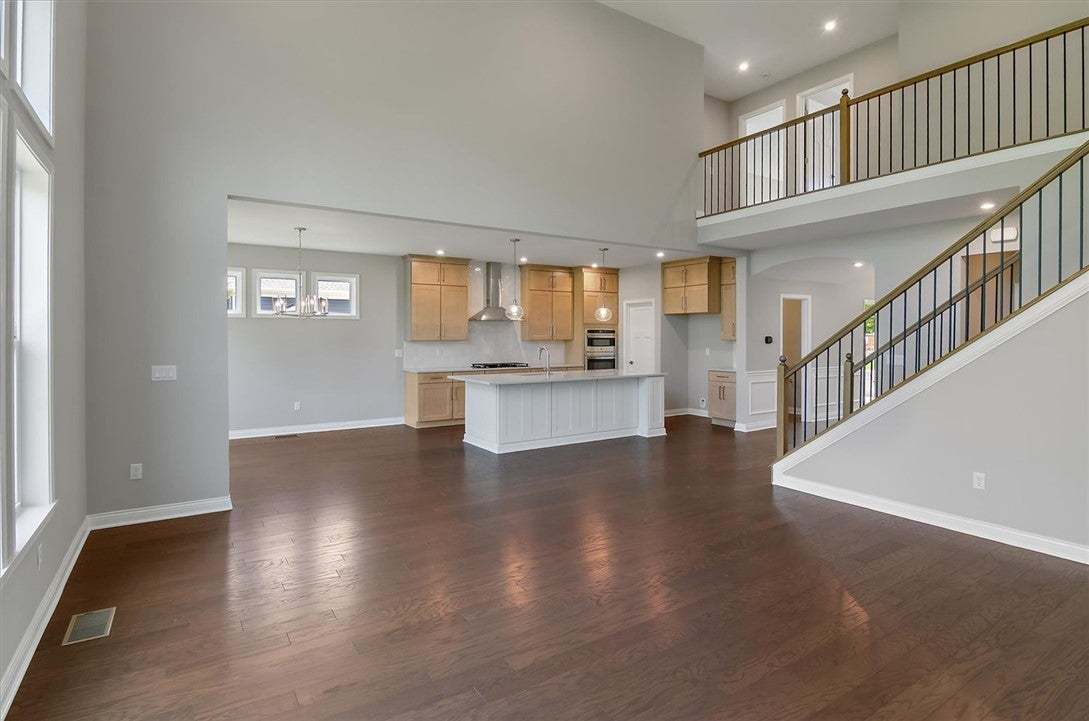 Rich hardwood flooring complements the soaring cei