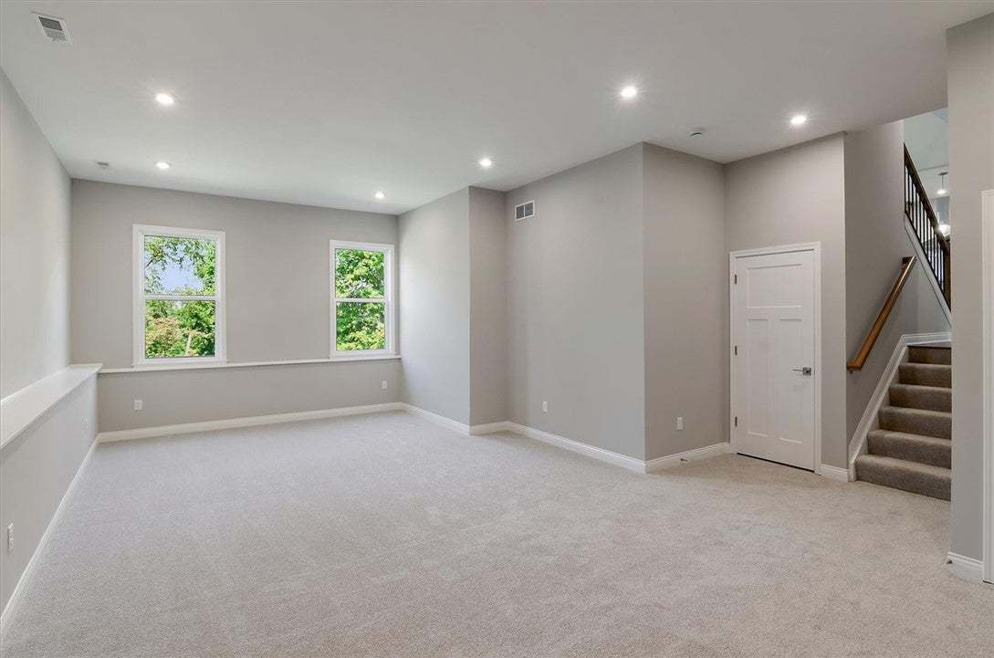 Recessed lighting and soft carpeting create a comf