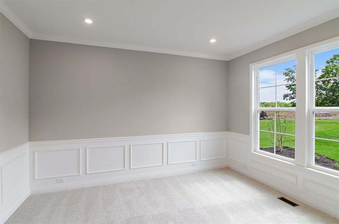 Elegant wainscoting and plush carpeting define thi