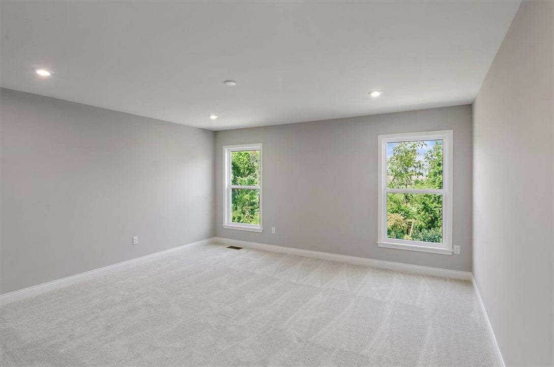 Plush carpeting and recessed lighting create a com