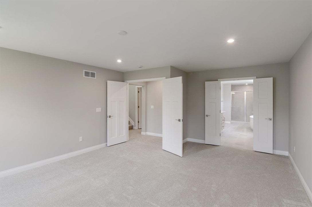 Double doors open to reveal an attached private ba