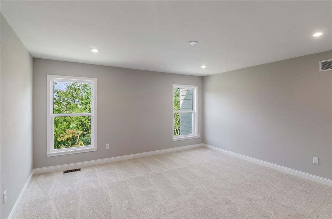 Plush carpeting and recessed lighting create a com