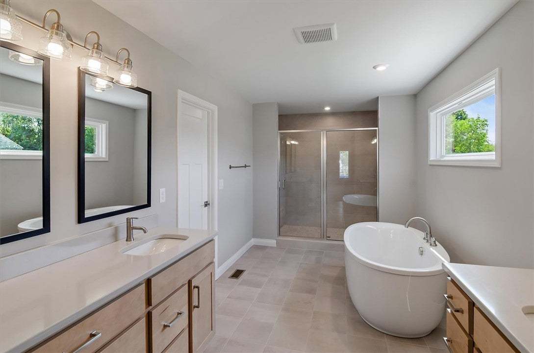 A modern bathroom features a freestanding soaking