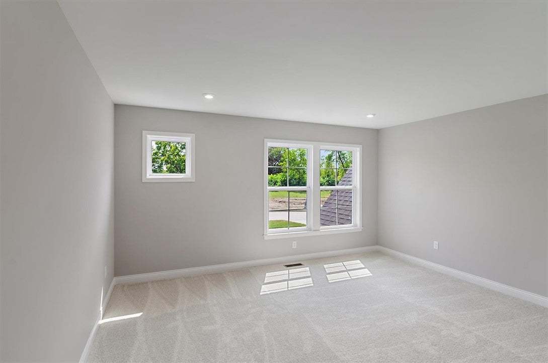 Plush carpeting and recessed lighting create a com