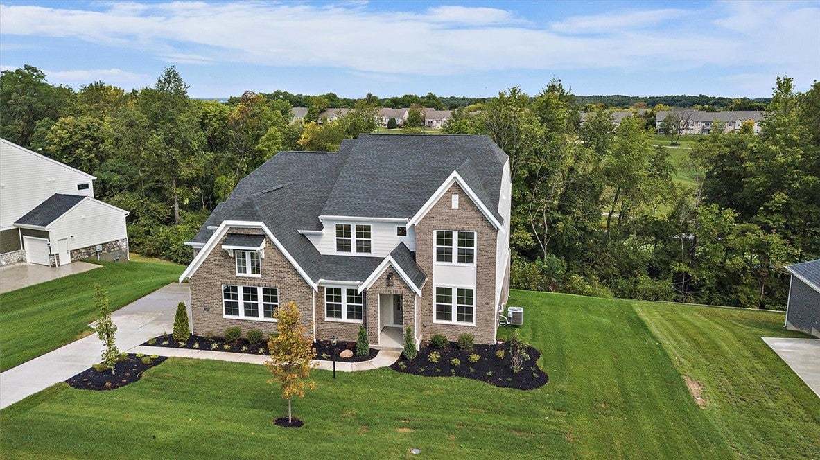 Manicured lawns and classic brickwork define this