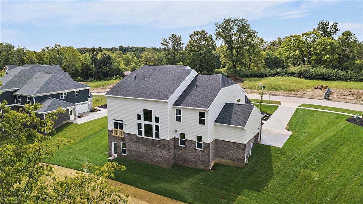 A classic brick and siding exterior stands surroun