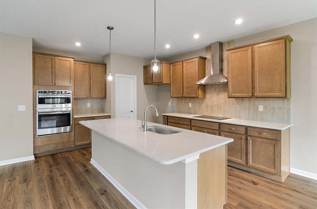 Rich wood cabinetry contrasts beautifully with pal