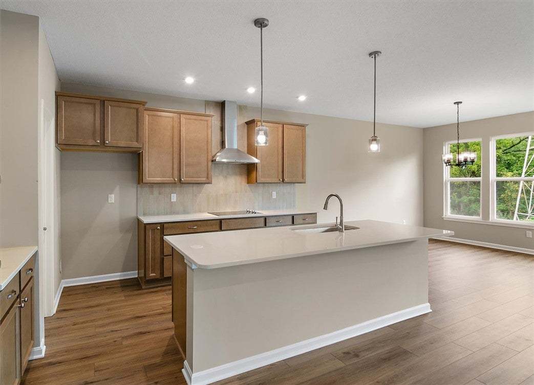 Rich wood flooring runs through this airy space wi