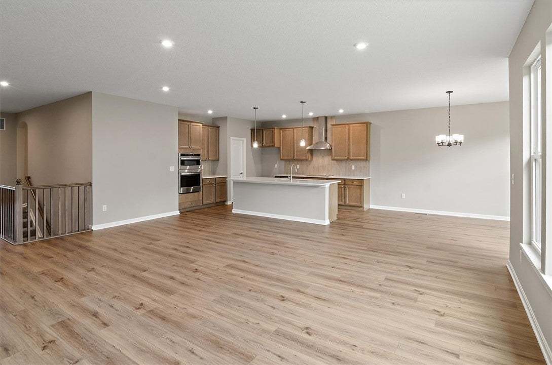 Gleaming wood floors anchor this open kitchen and