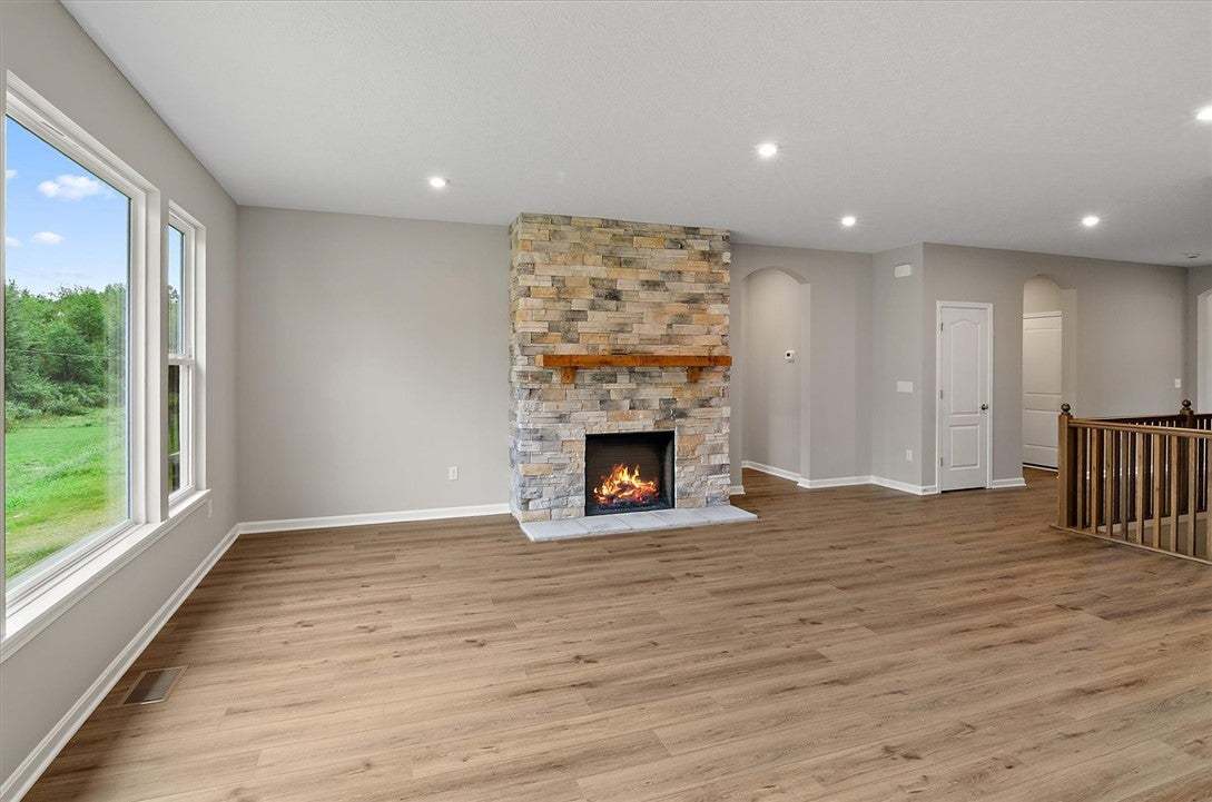 A stone fireplace anchors the living space, framed