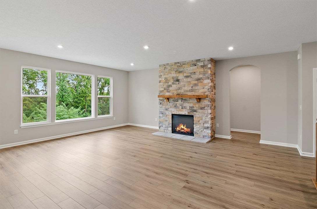 Rich wood-textured flooring flows toward a floor-t