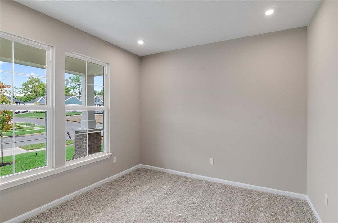 Recessed lighting and wall-to-wall carpeting defin