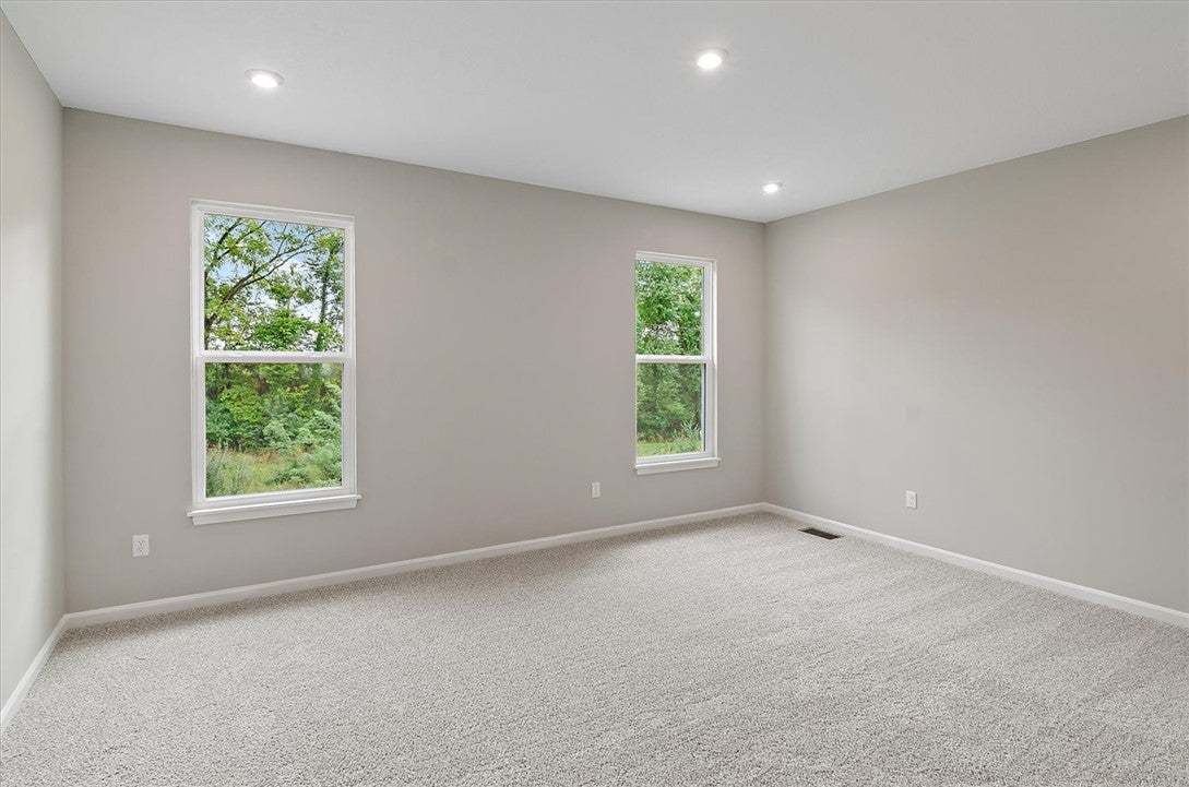 Sunlight streams through large windows into this s