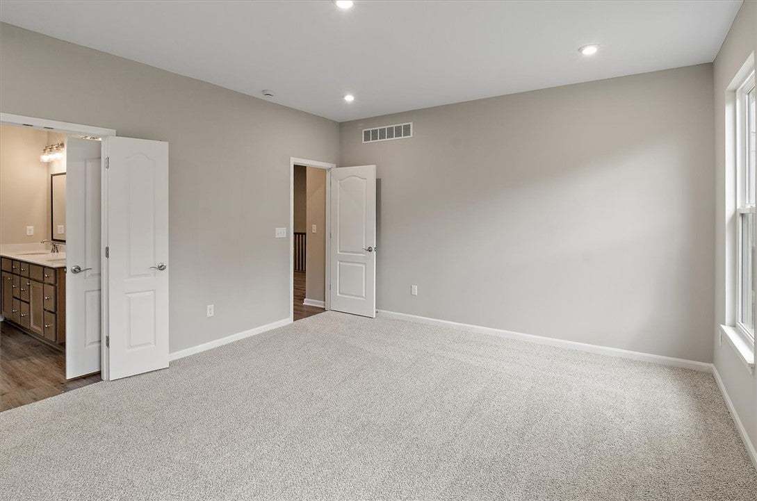 Recessed lighting and soft carpeting create a peac