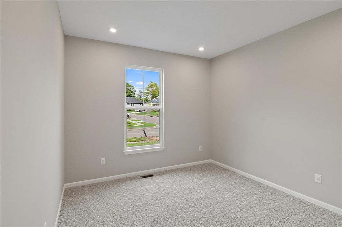 Recessed lighting and soft carpeting create a comf