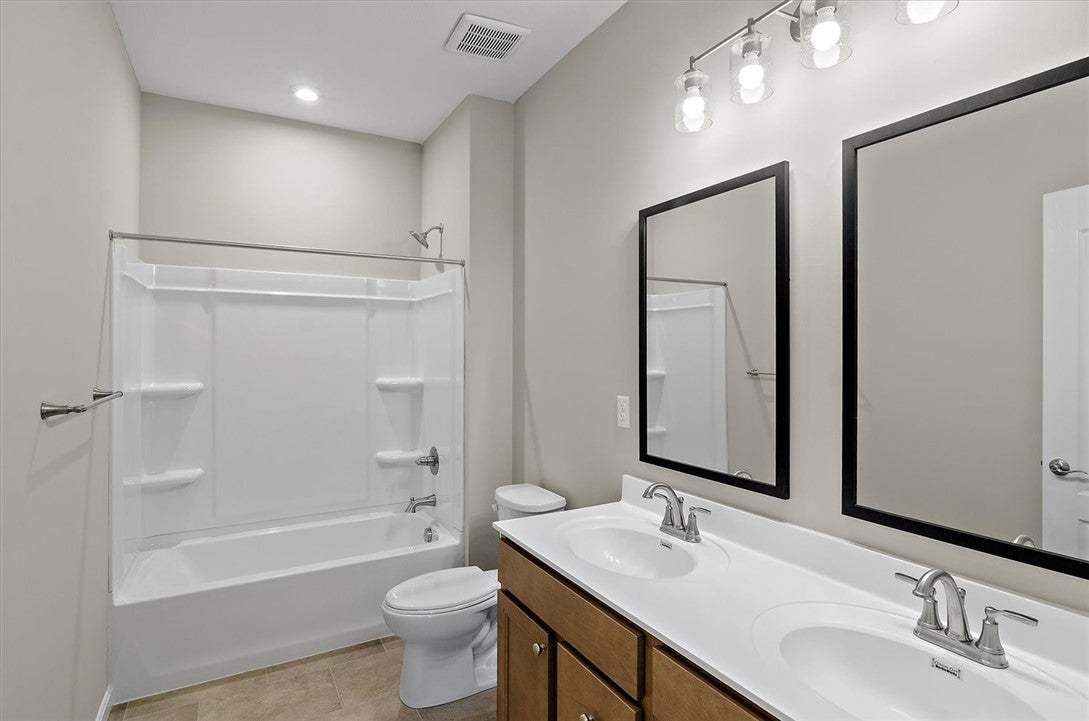 Clean lines and a spacious dual vanity define this