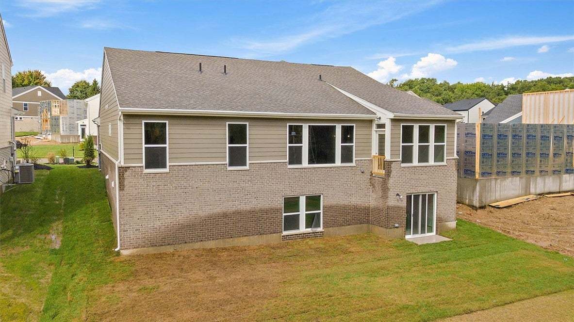 A classic brick and siding exterior stands under a