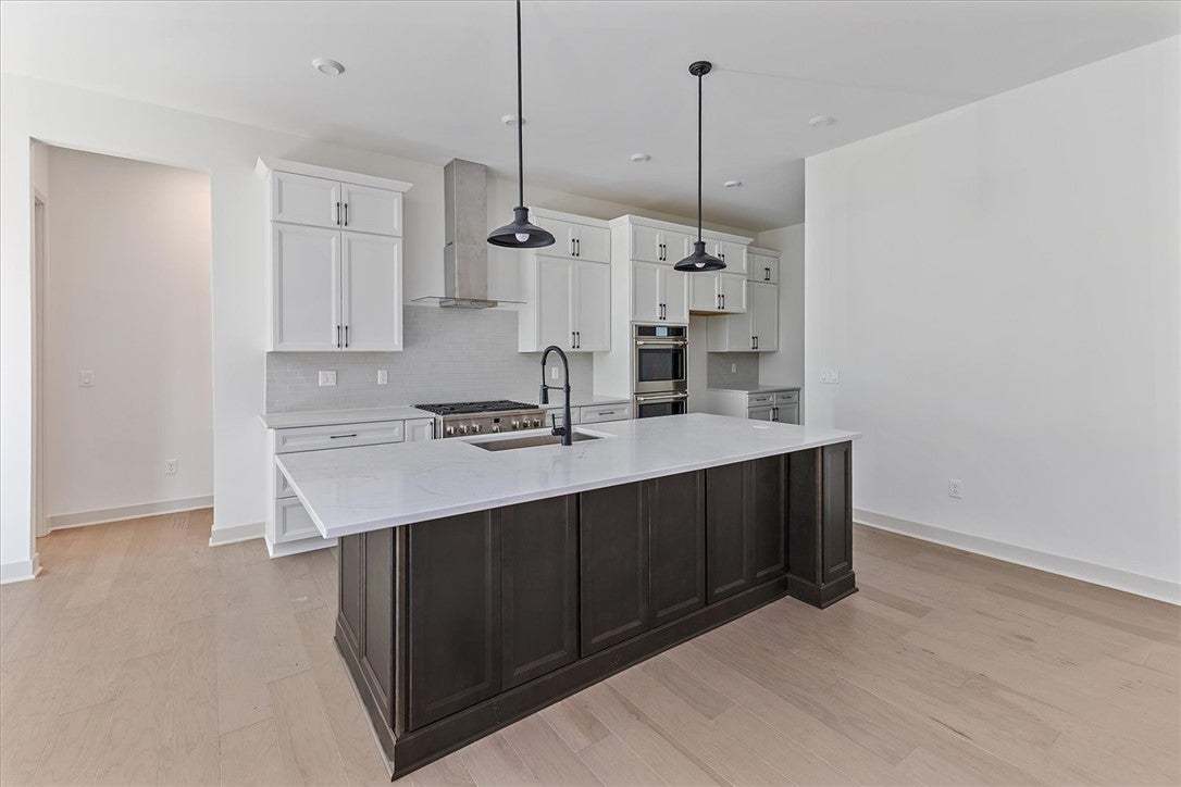 Gleaming hardwood floors and a spacious stone-topp