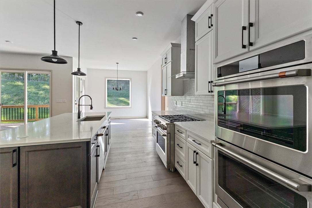 Gleaming stone countertops and stainless appliance