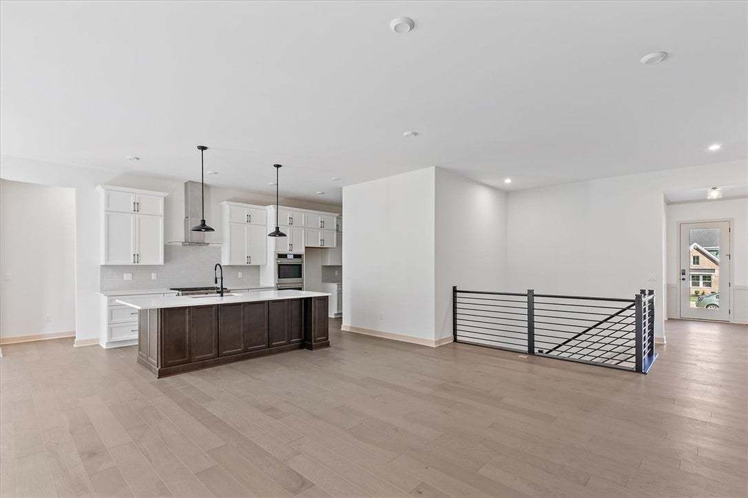 Gleaming hardwood floors flow throughout the open
