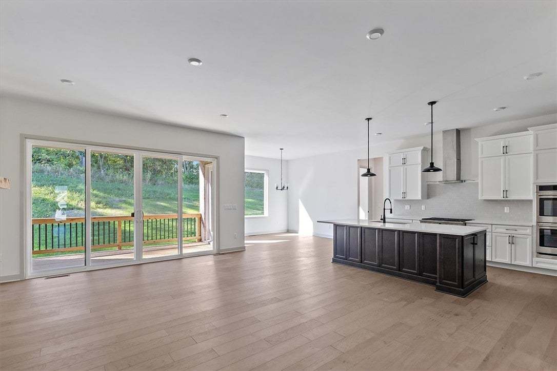 Hardwood floors and sliding glass doors define thi