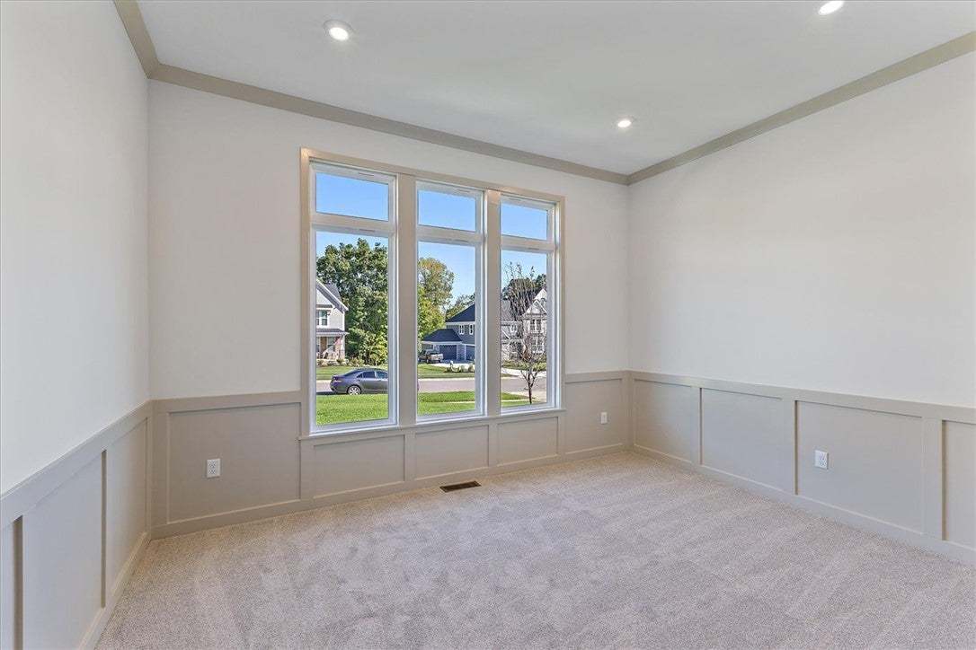 Classic wainscoting and large windows frame views