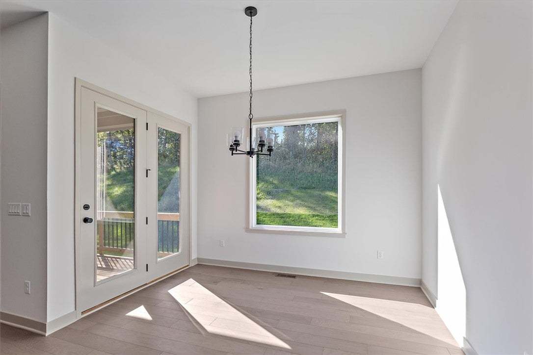 Gleaming hardwood floors and double glass doors de