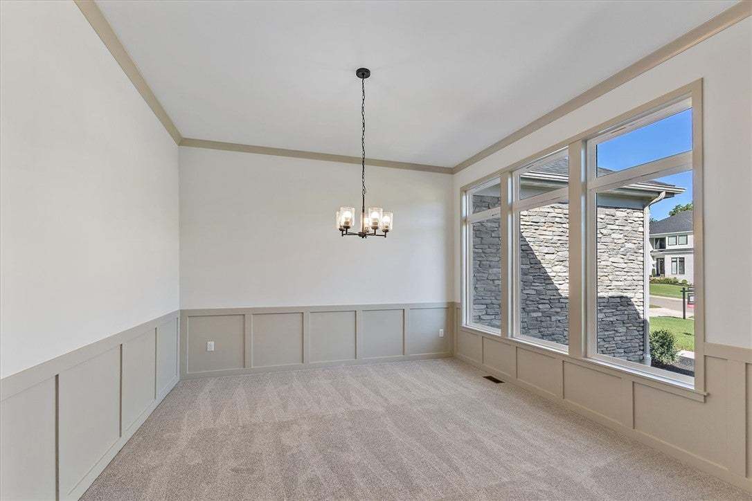 Sizable windows flood this elegant dining room wit