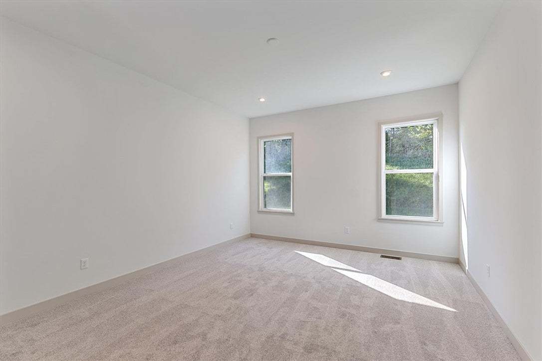 Plush carpeting and recessed lighting create a com