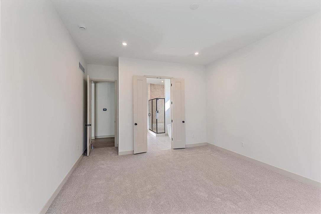 Plush carpeting and recessed lighting create a com