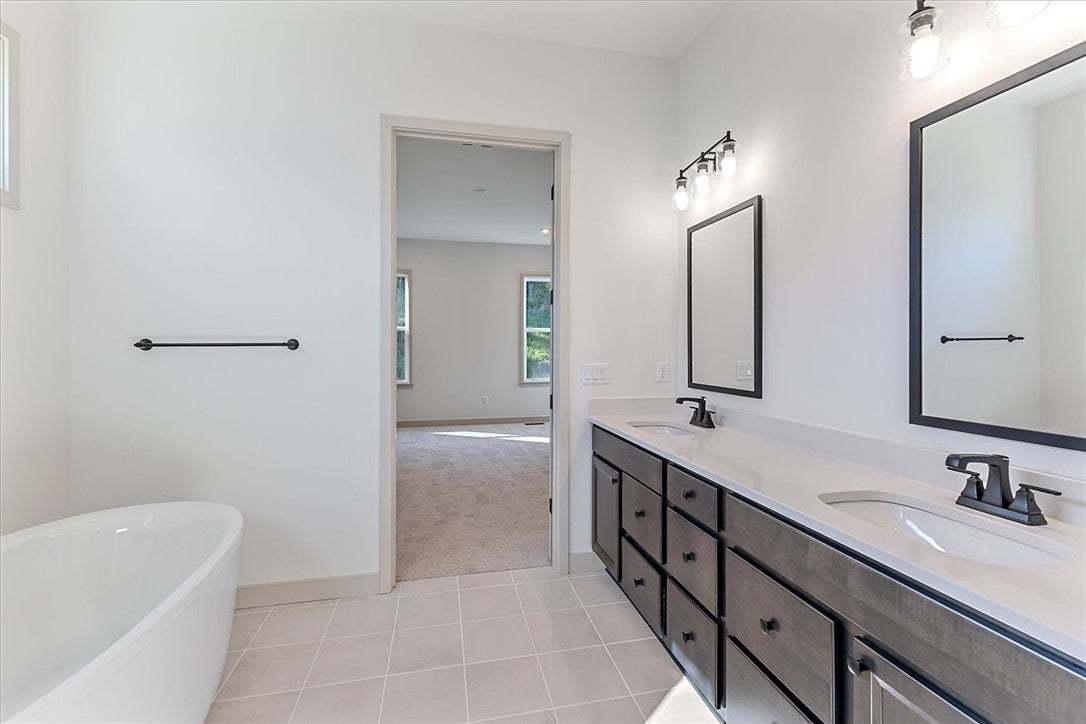 A spacious double vanity and freestanding soaking