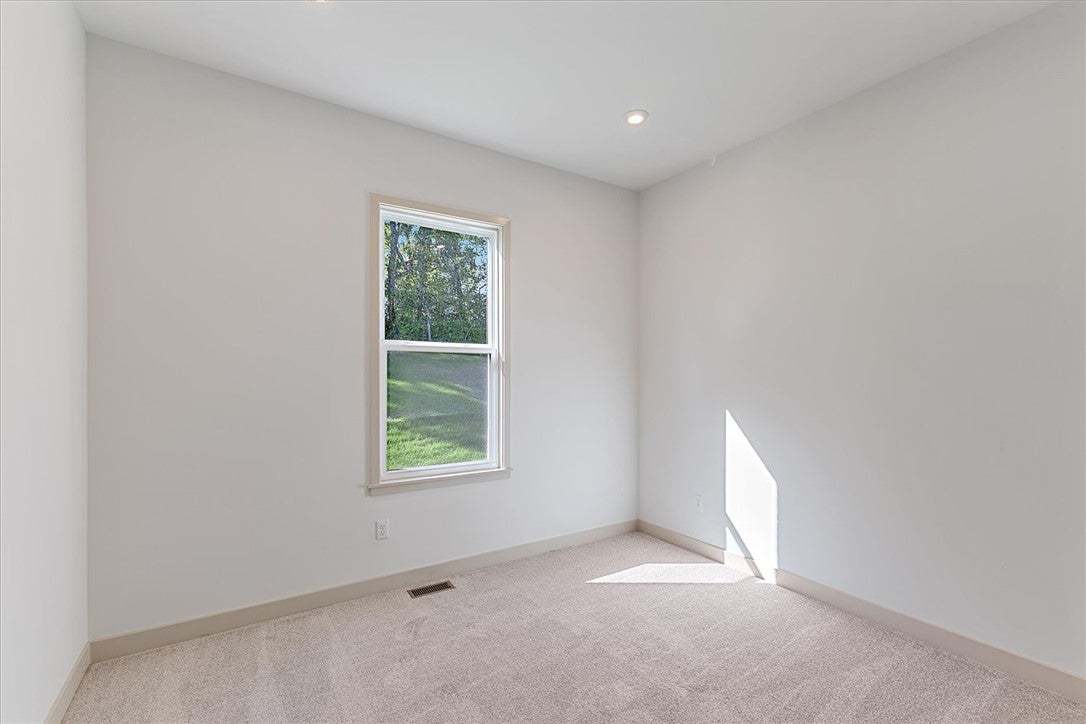 Plush carpeting and recessed lighting define this
