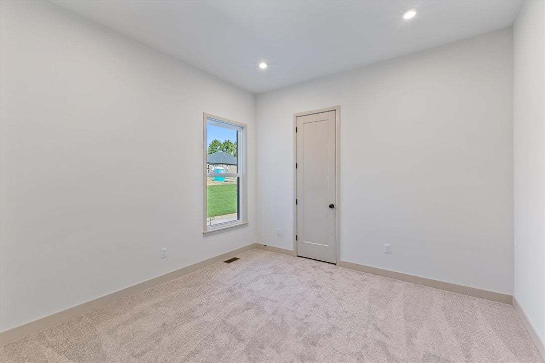 Recessed lighting and soft carpeting create a sere
