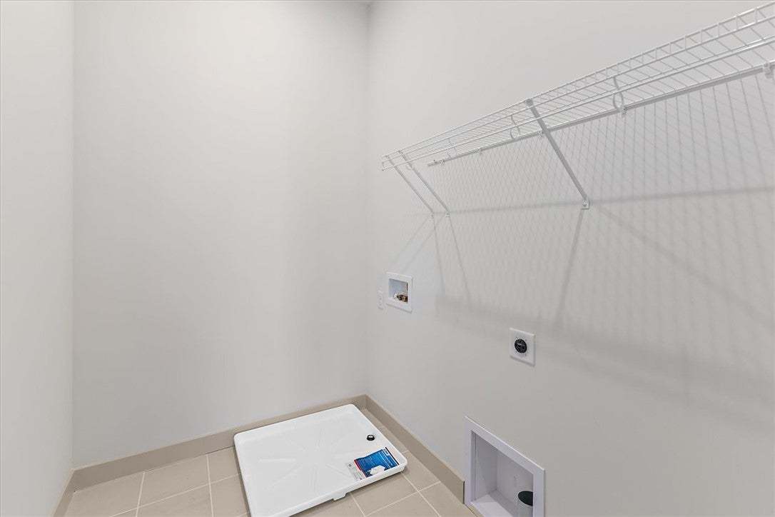Functional laundry hookups sit ready alongside pra